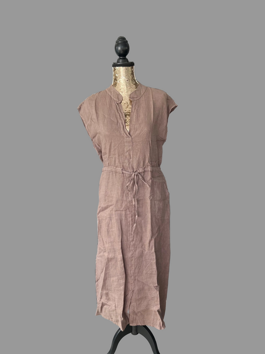 Brown jumpsuit on a mannequin in a room with a door and chair visible.